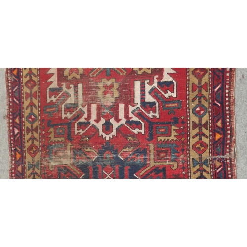 136 - A RED GROUND KARADJA RUNNERwith five geometric medallions and beige borders, 317cm long x 94cm wide... 