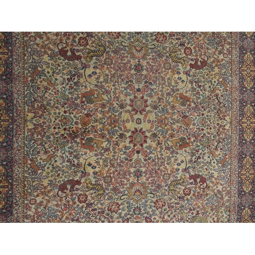 137 - *WITHDRAWN* A CREAM GROUND PERSIAN TEHERAN RUGwith floral all over design featuring stylized big cat... 