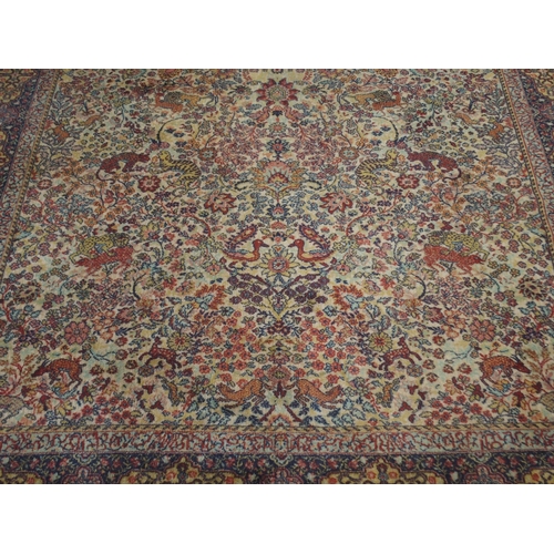 137 - *WITHDRAWN* A CREAM GROUND PERSIAN TEHERAN RUGwith floral all over design featuring stylized big cat... 