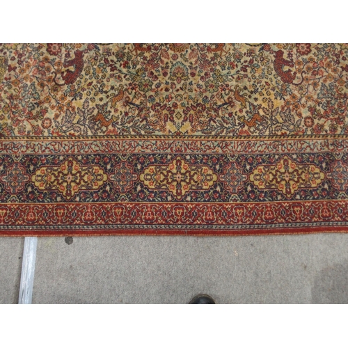 137 - *WITHDRAWN* A CREAM GROUND PERSIAN TEHERAN RUGwith floral all over design featuring stylized big cat... 