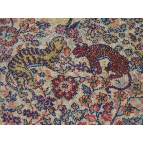 137 - *WITHDRAWN* A CREAM GROUND PERSIAN TEHERAN RUGwith floral all over design featuring stylized big cat... 