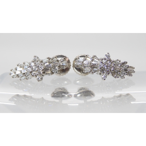 863 - A PAIR OF PLATINUM DIAMOND CLUSTER EARRINGSset with both baguette and brilliant cut diamonds to an e... 