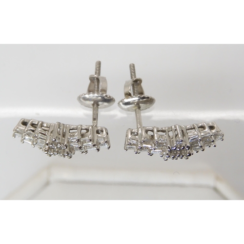 863 - A PAIR OF PLATINUM DIAMOND CLUSTER EARRINGSset with both baguette and brilliant cut diamonds to an e... 