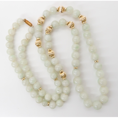 867 - A STRING OF PALE GREEN HARDSTONE BEADSwith 14k clasp and beads, length 67cm, weight 70.8gms... 