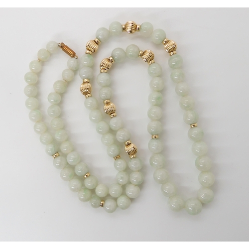 867 - A STRING OF PALE GREEN HARDSTONE BEADSwith 14k clasp and beads, length 67cm, weight 70.8gms... 