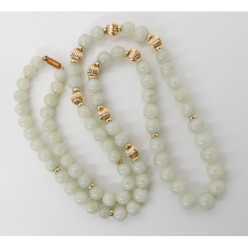 867 - A STRING OF PALE GREEN HARDSTONE BEADSwith 14k clasp and beads, length 67cm, weight 70.8gms... 