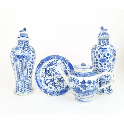 414 - A PAIR OF CHINESE BLUE AND WHITE VASES AND COVERSpainted with fruit and foliage, with shishi finials... 