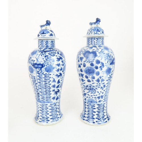 414 - A PAIR OF CHINESE BLUE AND WHITE VASES AND COVERSpainted with fruit and foliage, with shishi finials... 