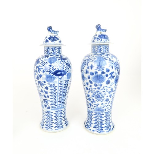 414 - A PAIR OF CHINESE BLUE AND WHITE VASES AND COVERSpainted with fruit and foliage, with shishi finials... 