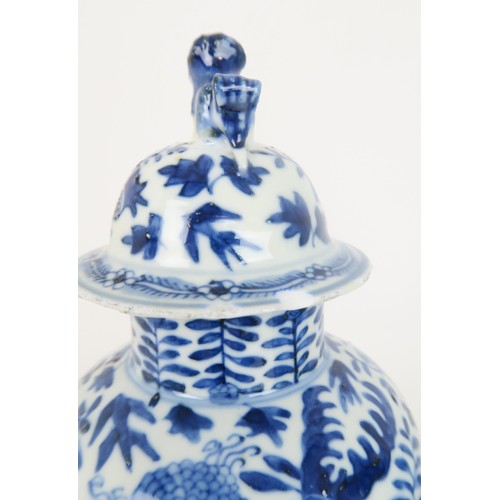 414 - A PAIR OF CHINESE BLUE AND WHITE VASES AND COVERSpainted with fruit and foliage, with shishi finials... 