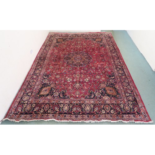 131A - A RED GROUND MESHED RUG with dark blue central medallion and matching spandrels, the field with trai... 