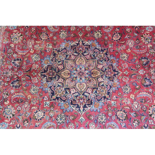 131A - A RED GROUND MESHED RUG with dark blue central medallion and matching spandrels, the field with trai... 