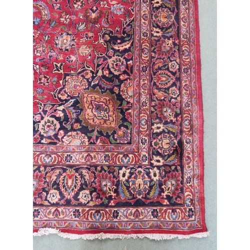 131A - A RED GROUND MESHED RUG with dark blue central medallion and matching spandrels, the field with trai... 