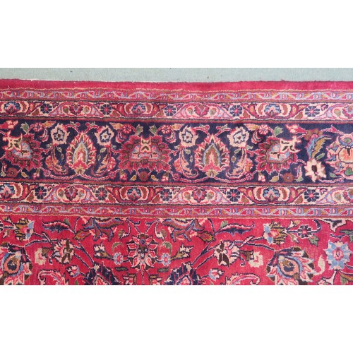 131A - A RED GROUND MESHED RUG with dark blue central medallion and matching spandrels, the field with trai... 