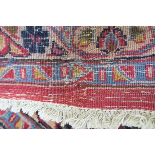 131A - A RED GROUND MESHED RUG with dark blue central medallion and matching spandrels, the field with trai... 