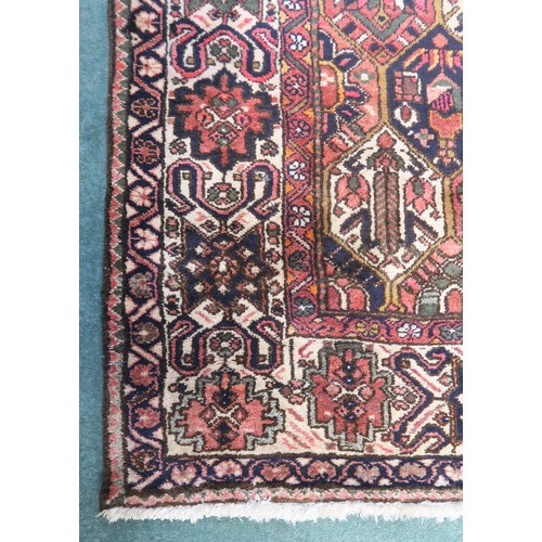 133A - A MULTICOLOURED GROUND BAKHTIARI RUGwith all over geometric lozenge design and a cream geometric mul... 