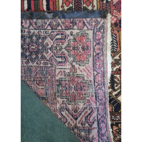 133A - A MULTICOLOURED GROUND BAKHTIARI RUGwith all over geometric lozenge design and a cream geometric mul... 