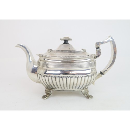 483 - A GEORGE III IRISH SILVER TEAPOTof squat rectangular form, the body fluted with reeded rims, the lid... 