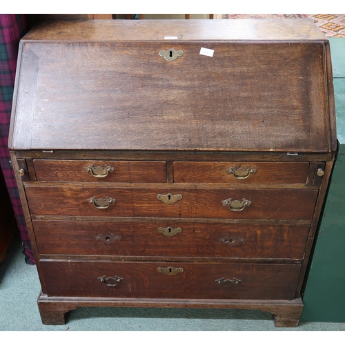 61 - A Georgian oak writing bureau with fitted fall front writing compartment above two over three drawer... 