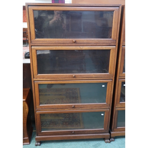 66 - A 20th century hardwood four tier fall front glazed bookcase on paw feet, 166cm high x 90cm wide x 3... 