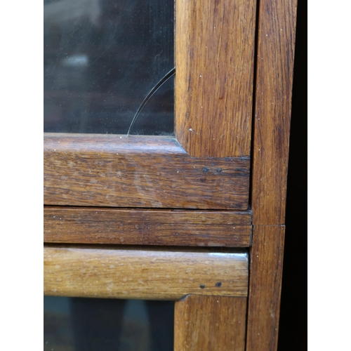 66 - A 20th century hardwood four tier fall front glazed bookcase on paw feet, 166cm high x 90cm wide x 3... 