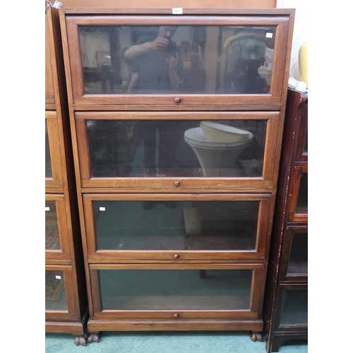 67 - A 20th century hardwood four tier fall front glazed bookcase on paw feet, 166cm high x 90cm wide x 3... 