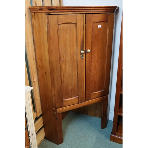 83 - A 20th century pine two door corner cabinet