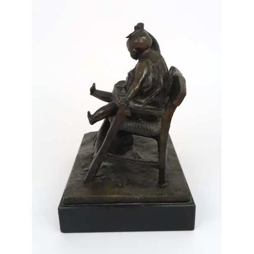 349 - A BRONZE OF A CHILD IN HIGH CHAIR