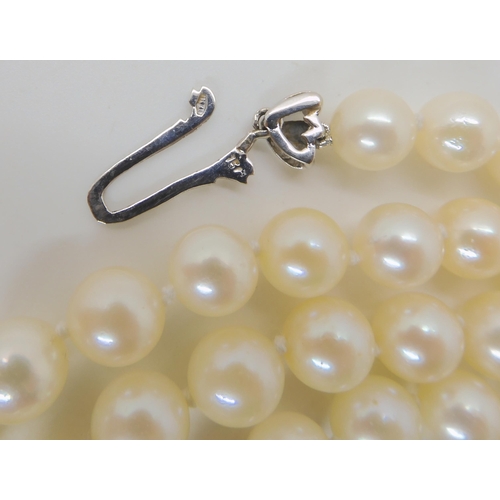 712 - AN OPERA LENGTH OF PEARLS WITH AN 18CT SAPPHIRE AND DIAMOND CLASP