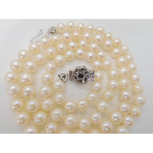 712 - AN OPERA LENGTH OF PEARLS WITH AN 18CT SAPPHIRE AND DIAMOND CLASP