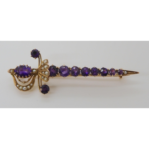 807 - A 9CT GOLD AMETHYST AND PEARL SWORD BROOCH