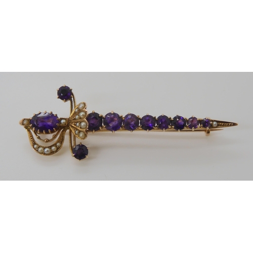 807 - A 9CT GOLD AMETHYST AND PEARL SWORD BROOCH