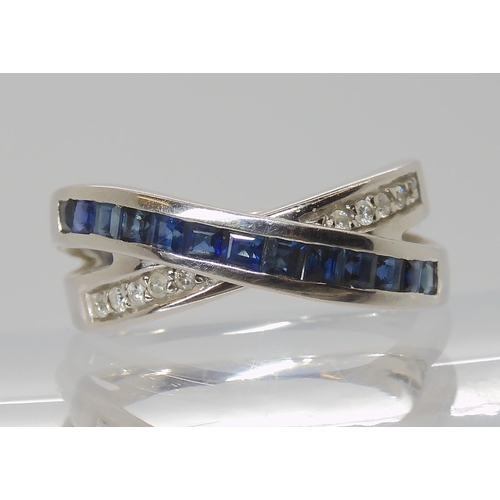 811 - A 14K GOLD SAPPHIRE & DIAMOND CROSS OVER RING