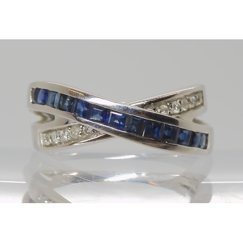 811 - A 14K GOLD SAPPHIRE & DIAMOND CROSS OVER RING