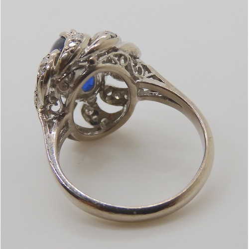 819 - A 14K WHITE GOLD BLUE GEMSTONE AND DIAMOND RING