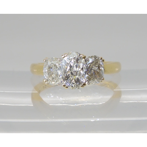 821 - AN 18CT GOLD THREE STONE DIAMOND RING