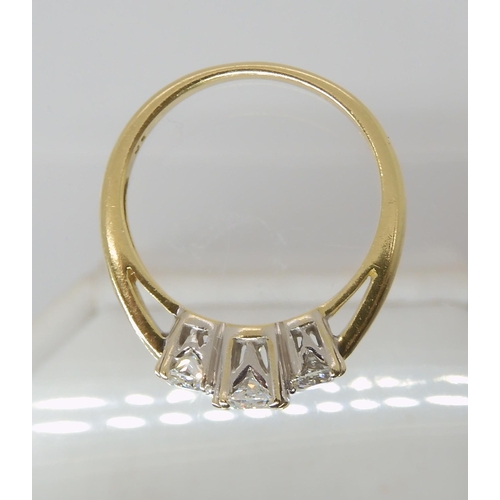 821 - AN 18CT GOLD THREE STONE DIAMOND RING