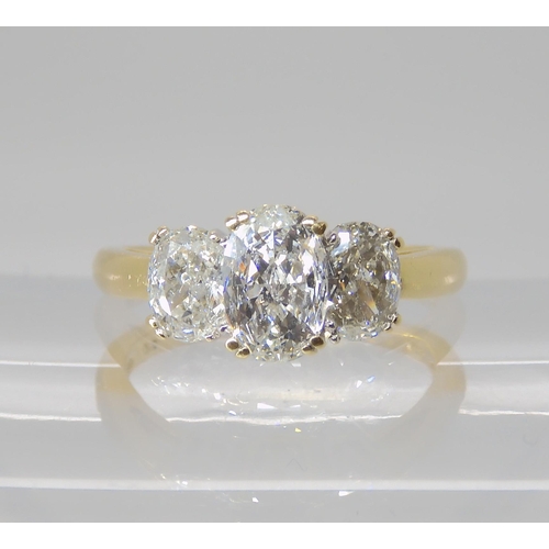 821 - AN 18CT GOLD THREE STONE DIAMOND RING