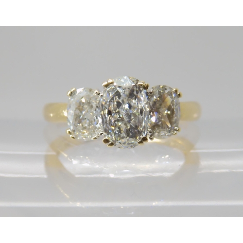 821 - AN 18CT GOLD THREE STONE DIAMOND RING