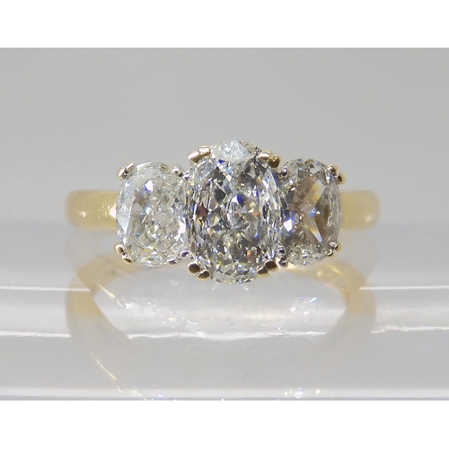 821 - AN 18CT GOLD THREE STONE DIAMOND RING