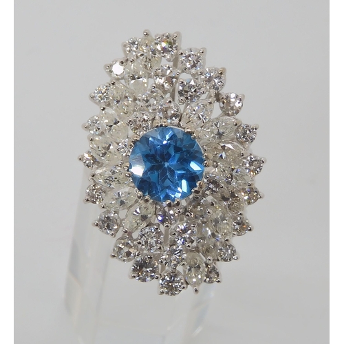 822 - A WHITE METAL DIAMOND AND BLUE TOPAZ CLUSTER RING