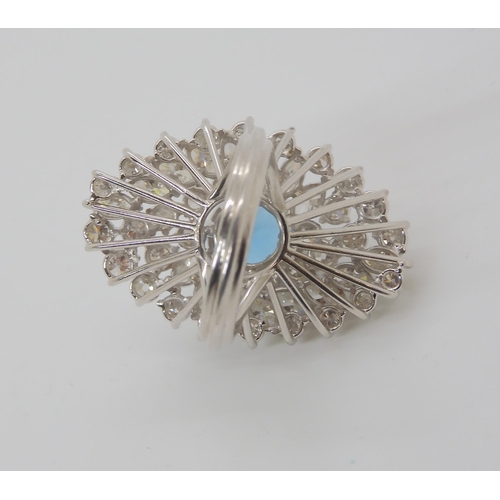 822 - A WHITE METAL DIAMOND AND BLUE TOPAZ CLUSTER RING