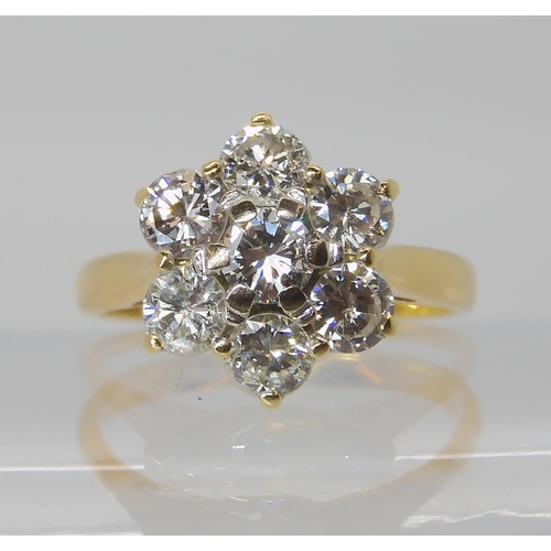 823 - AN 18CT GOLD DIAMOND FLOWER RING