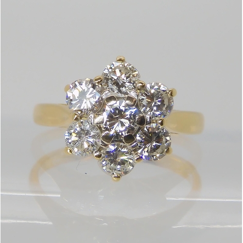 823 - AN 18CT GOLD DIAMOND FLOWER RING