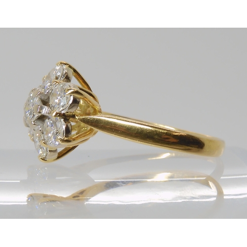 823 - AN 18CT GOLD DIAMOND FLOWER RING