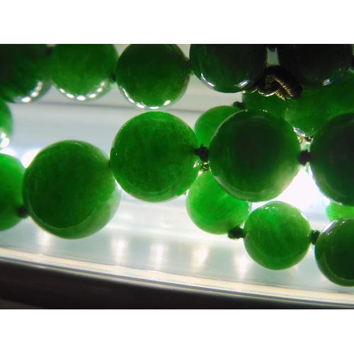 836 - A STRING OF CHINESE GREEN HARDSTONE BEADS