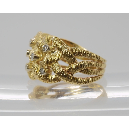 838 - AN 18CT GOLD DIAMOND SET KNOTWORK RING