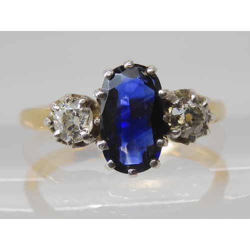 839 - A SAPPHIRE AND DIAMOND THREE STONE RING