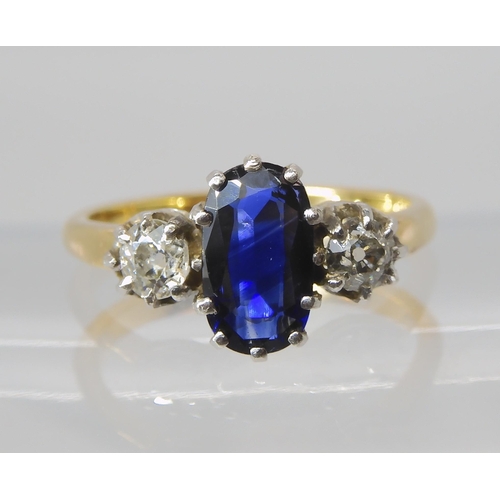 839 - A SAPPHIRE AND DIAMOND THREE STONE RING