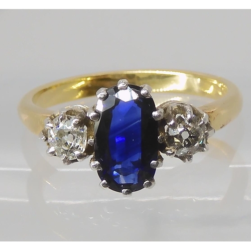 839 - A SAPPHIRE AND DIAMOND THREE STONE RING